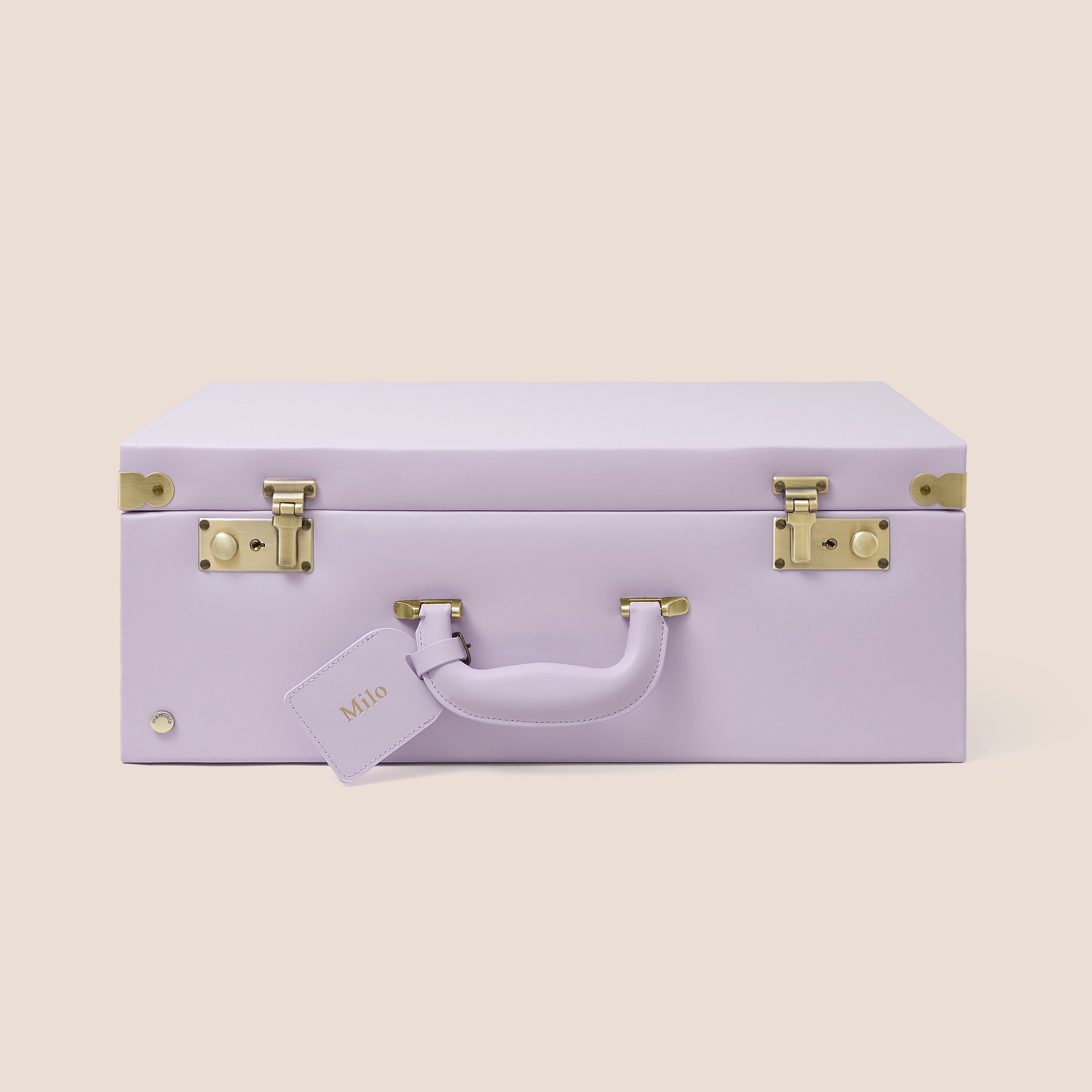 Lavender suitcase with gold accents on a beige background